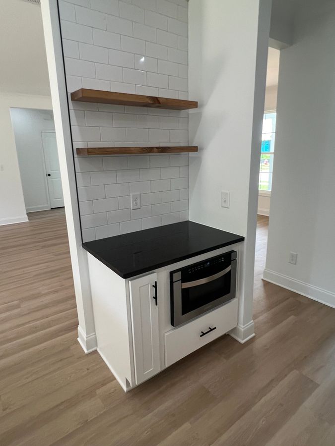 Interior detail of a BKA Builders custom kitchen with cabinet and tile selections